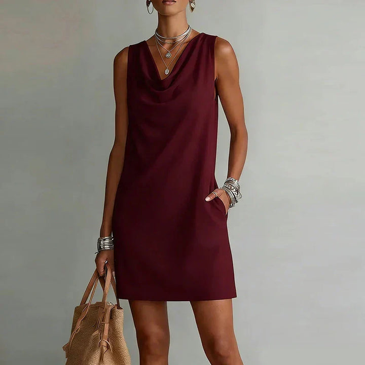 Lightweight women's mini dress, ideal for warm weather. Effortless style with a draped neckline & pockets.