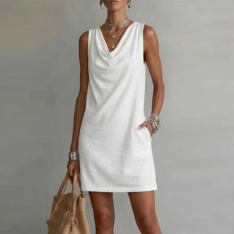Women's summer mini dress featuring a comfortable relaxed fit, draped neckline, and convenient pockets.