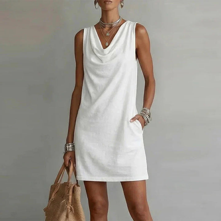 Women's summer mini dress featuring a comfortable relaxed fit, draped neckline, and convenient pockets.