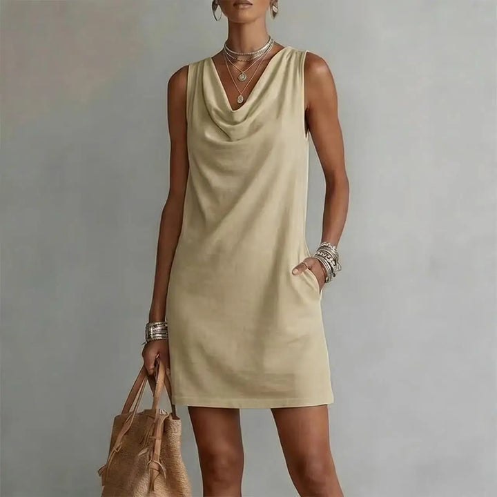 Women's casual sleeveless mini dress, lightweight, stylish. Features a draped neckline, relaxed fit & pockets.
