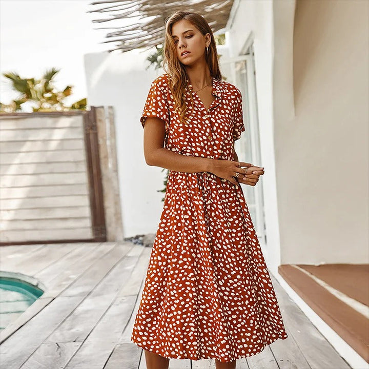 Model wearing a flowy women's printed summer midi dress, perfect for a casual day or stylish vacation.