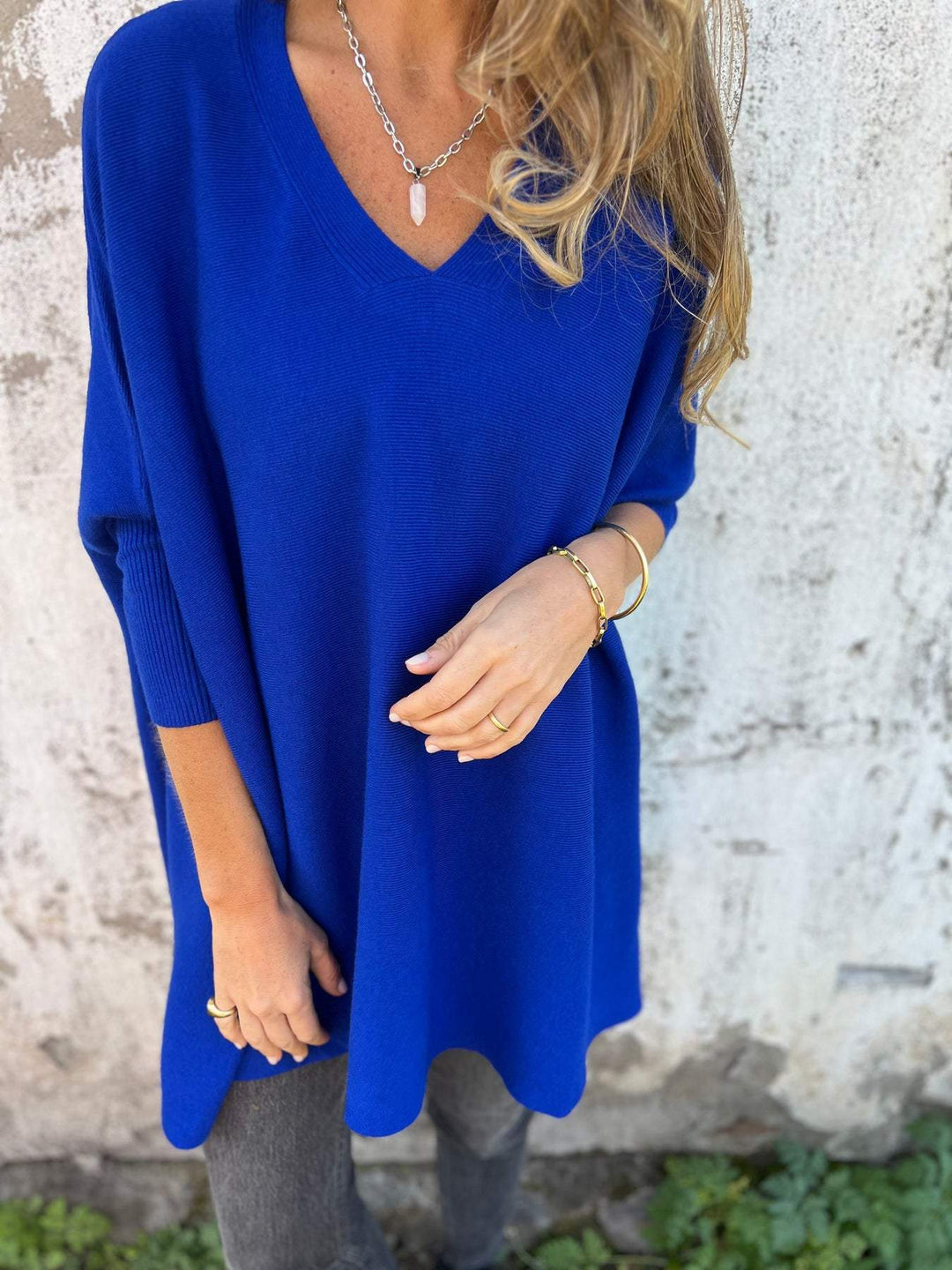 Relaxed fit V-neck tunic sweater for women, showcasing its flowy swing silhouette and versatile style for winter.