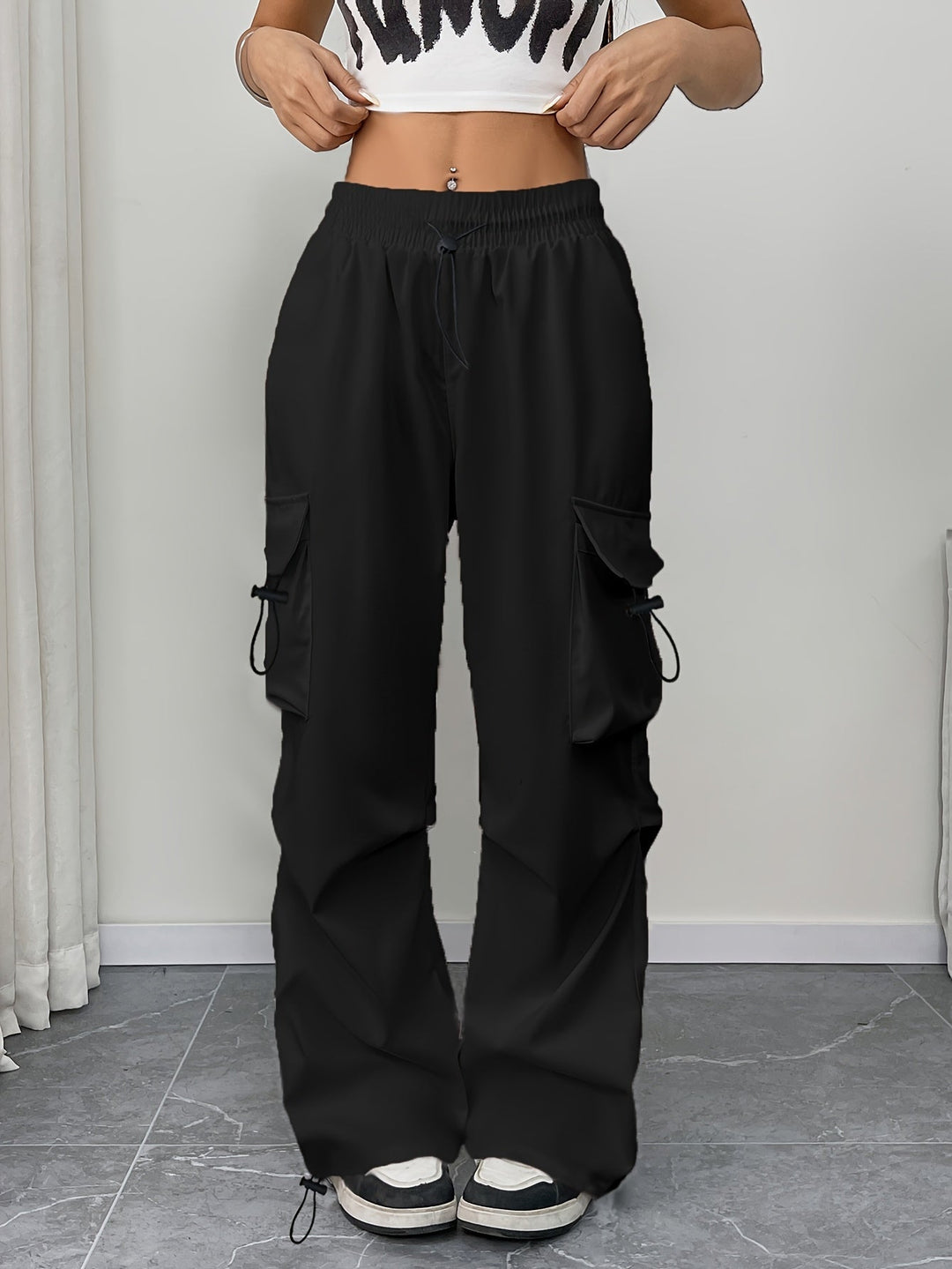 Comfortable women's wide leg cargo pants with drawstring waist & pockets. Ideal for travel & everyday wear.