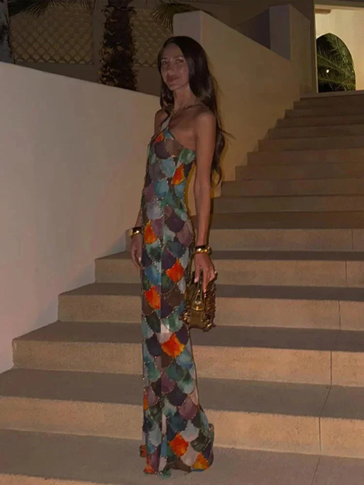 Formal women's halter neck maxi dress featuring a striking abstract scale print and elegant backless design.