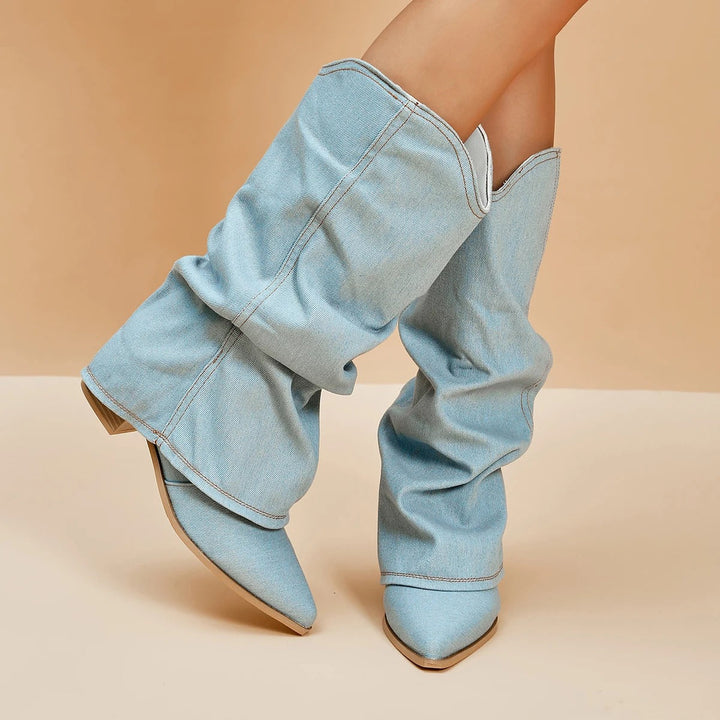 Close-up of women's pleated tall boots, showcasing unique texture, pointed toe, and sturdy block heel detail.