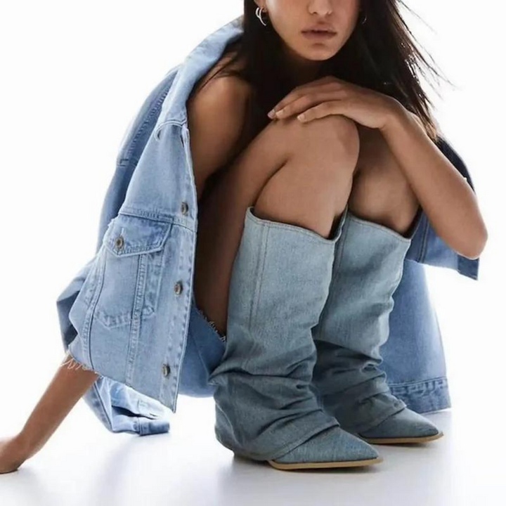 Detail shot of the pointed toe and robust block heel on elegant pleated tall boots for women's fashion.