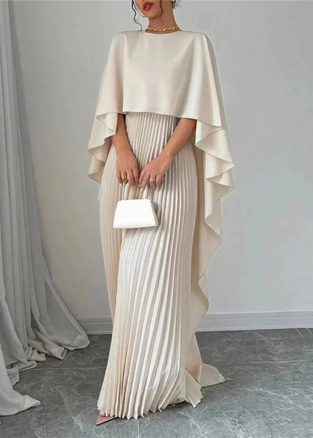 Elegant women's evening gown: long pleated maxi dress with sophisticated cape overlay, suitable for formal occasions.