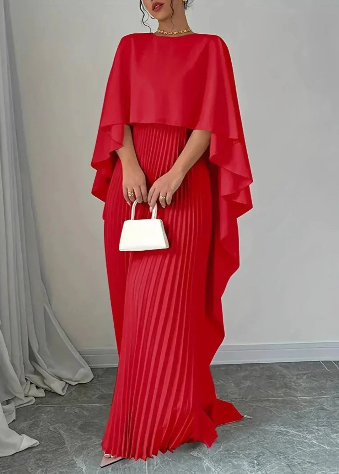 Women's elegant long pleated maxi dress with a dramatic cape overlay, perfect for formal occasions & black-tie events.