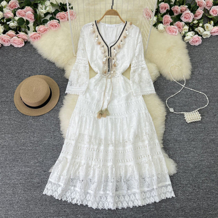 Chic women's flowy maxi dress featuring intricate lace details, bell sleeves, and a tiered skirt for boho elegance.