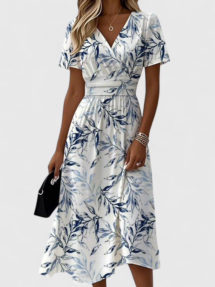 Women's elegant botanical print midi dress with V-neck and delicate flutter sleeves, perfect for summer events.