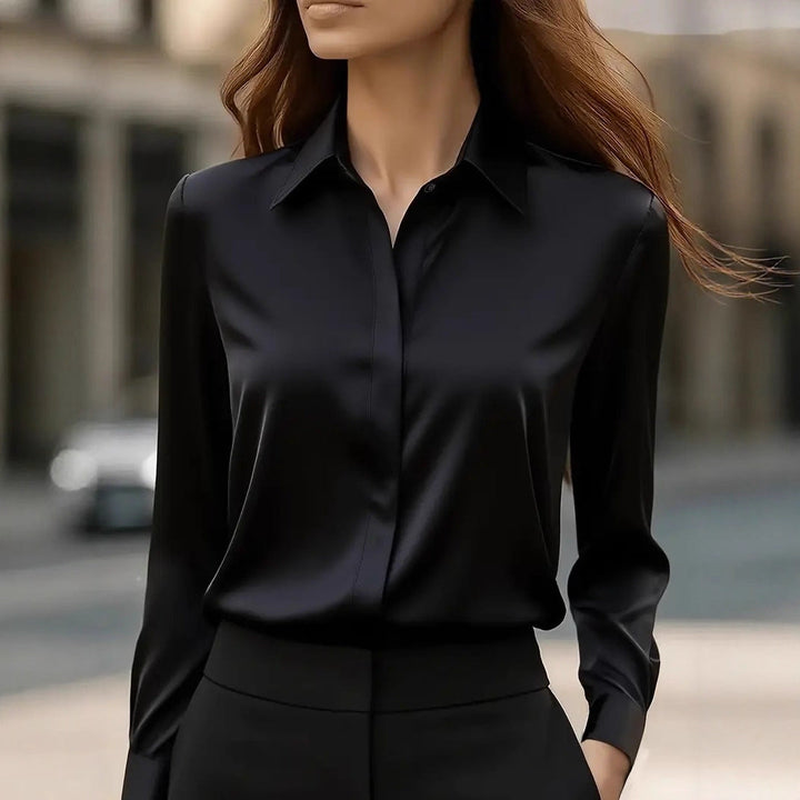 Classic women's elegant workwear blouse with button details, perfect for a professional office look.