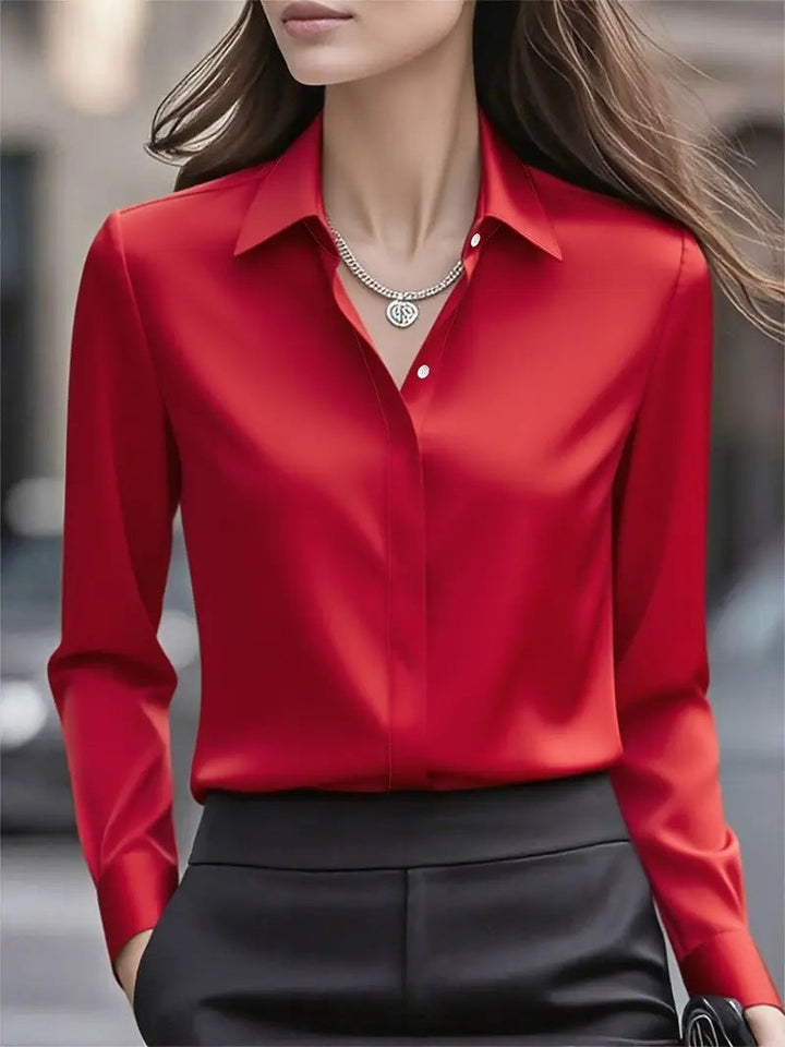 Chic women's professional blouse with elegant button accents, a versatile long-sleeve workwear top.