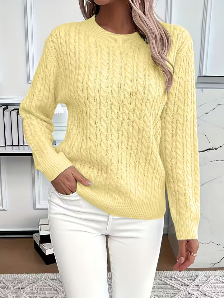 Versatile cable knit crew neck pullover for women. Great for layering and autumn fashion.