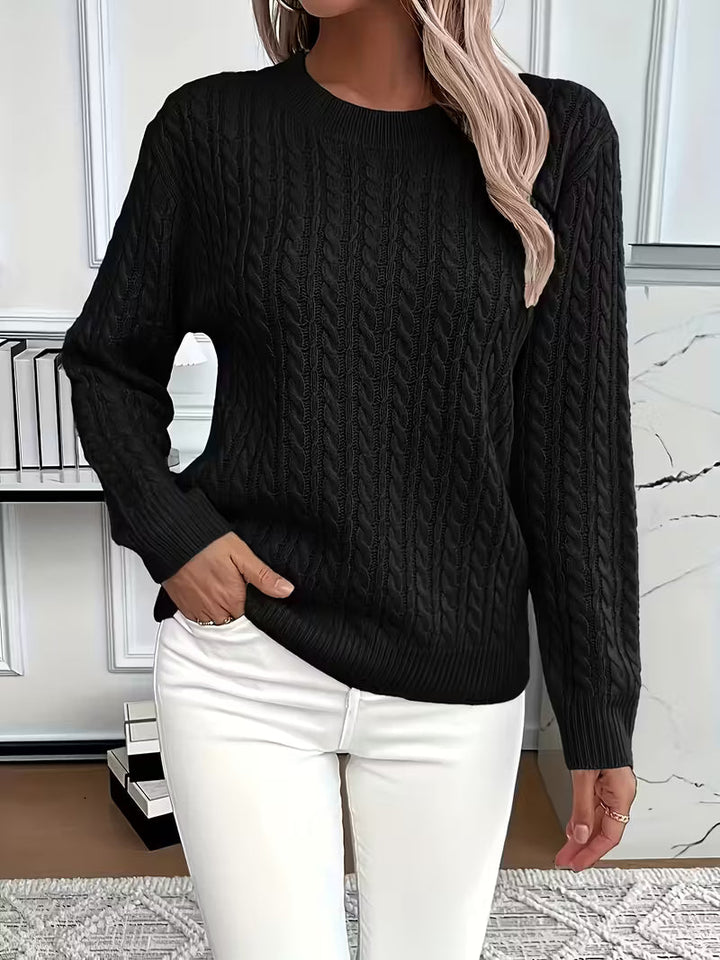 Elegant cable knit pattern on a comfortable crew neck women's sweater for autumn style.