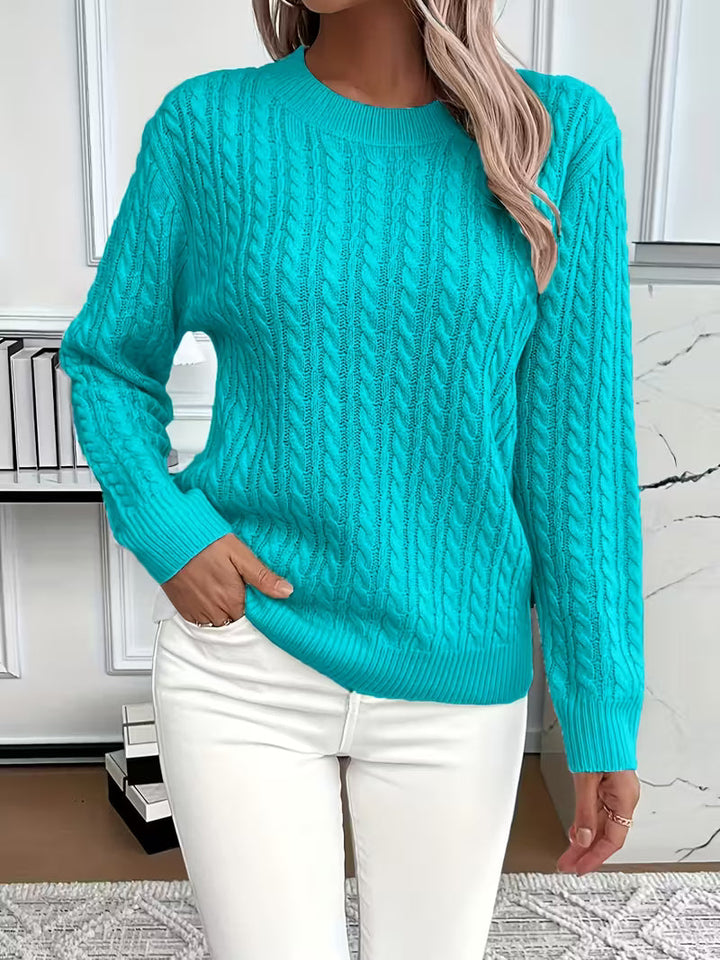 Women's autumn cable knit crew neck sweater, styled for a chic, relaxed look. A versatile pullover.