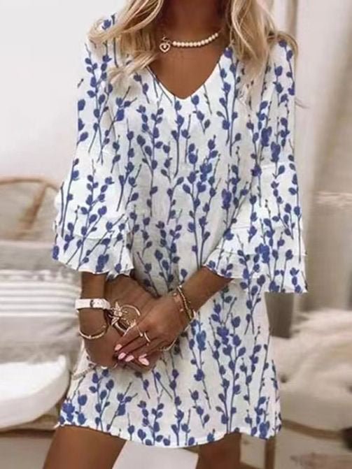 Relaxed fit women's mini dress with a vibrant marble swirl print and elegant flare sleeves. Great for summer fashion.