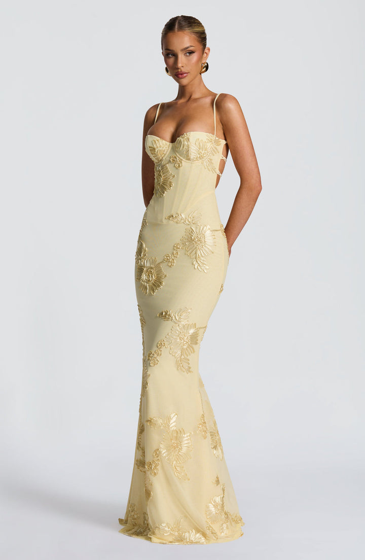 Formal evening gown featuring a flattering corset bodice, spaghetti straps & intricate floral details.
