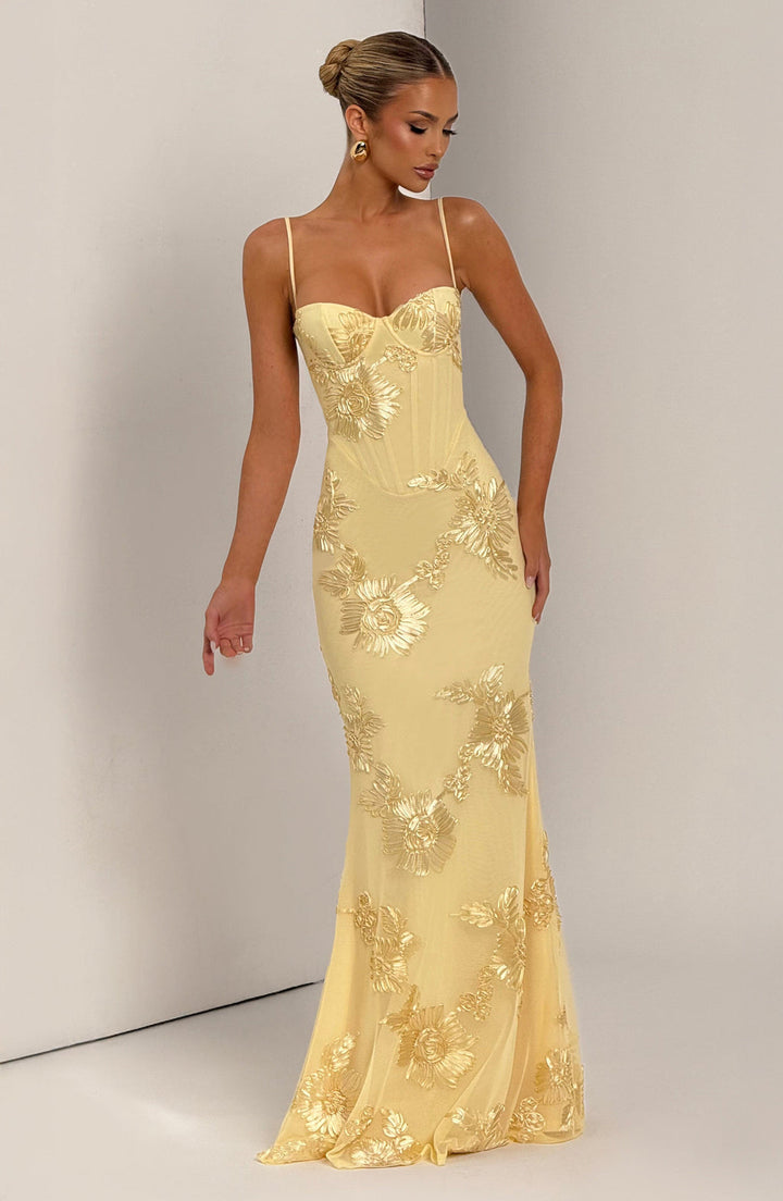 Luxurious wedding guest dress with a fitted corset, elegant floral appliqué & mermaid tail skirt.