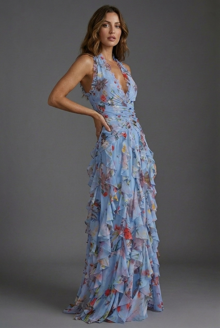 Summer party-ready women's maxi dress with a halterneck, beautiful floral print & flowy ruffle skirt.