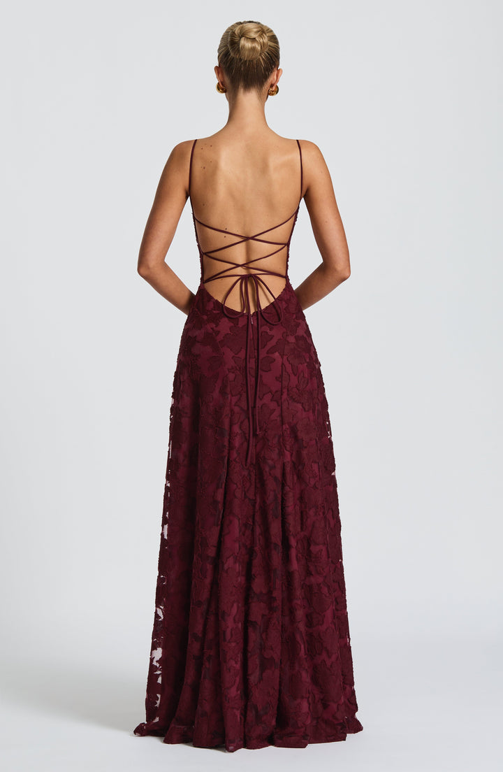 Women's long floral occasion dress, featuring a waterfall neckline that drapes beautifully and a lace-up back.