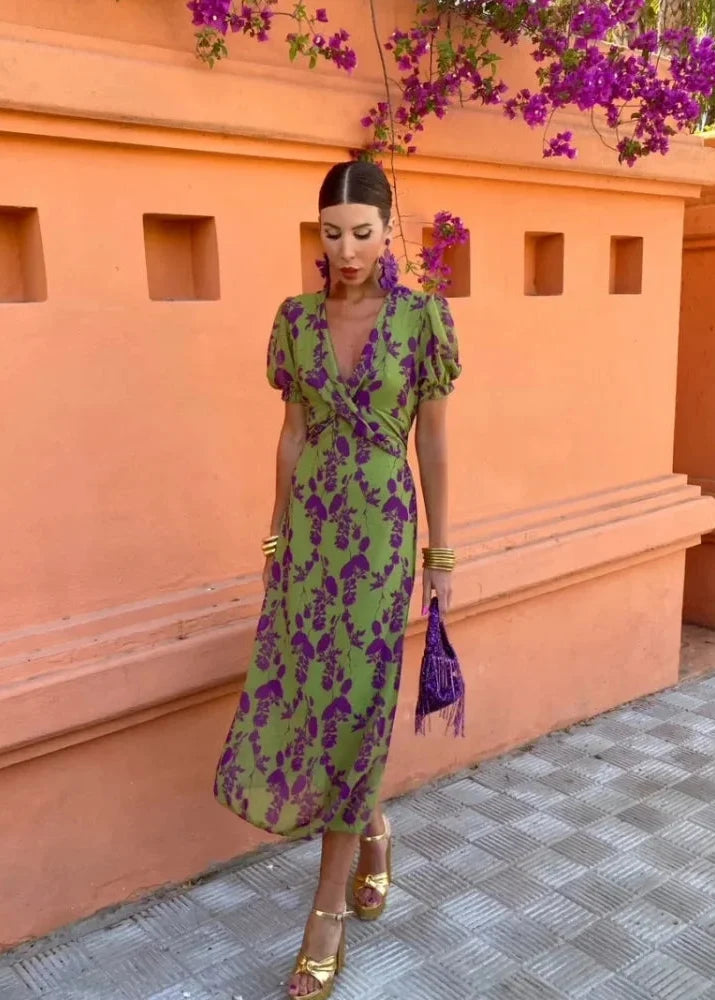 Feminine botanical print midi dress featuring an elegant wrap V-neck and stylish puff sleeves, ideal for events.