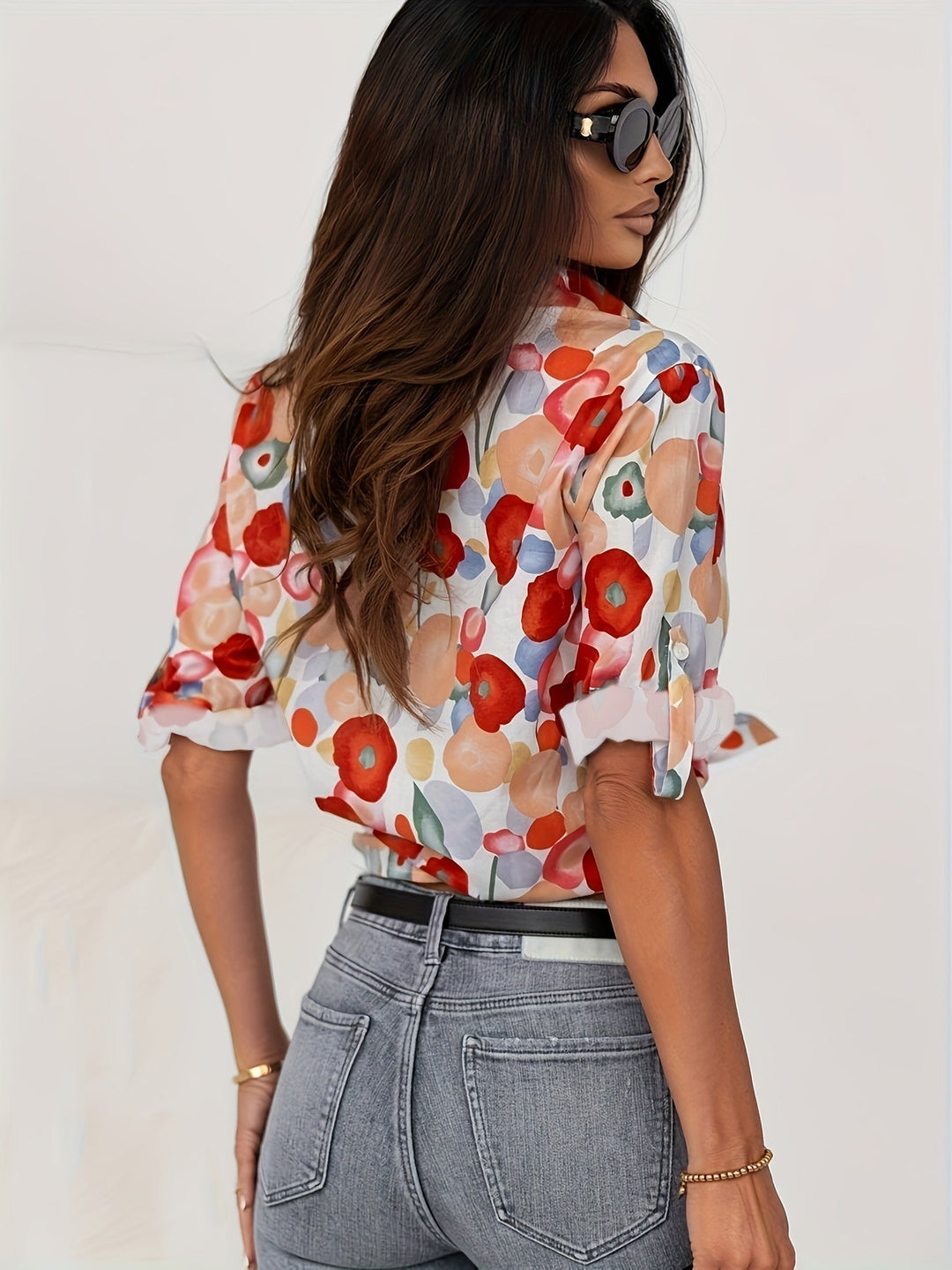 Artistic floral print long sleeve blouse for women. Features a classic button-down design, ideal for an elegant look.