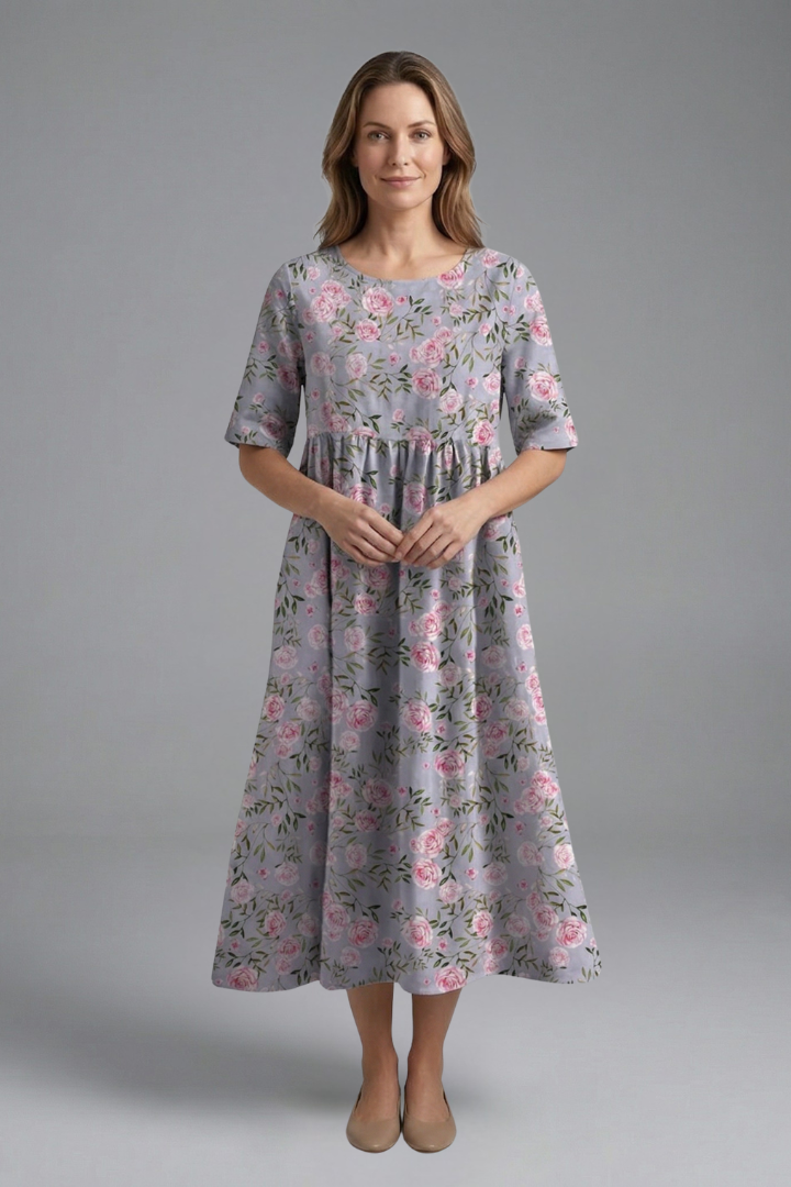 Women's short sleeve floral midi dress with a classic round neck and a flowing, flared skirt. Effortless style.