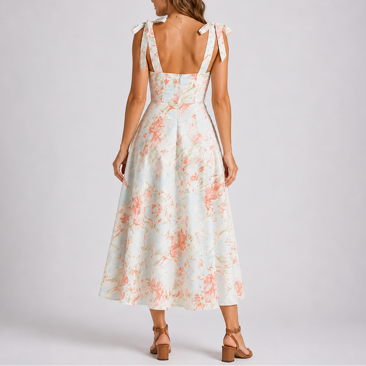 Stylish women's floral midi dress with ruched accents & adjustable ties. A versatile A-line dress for summer events.