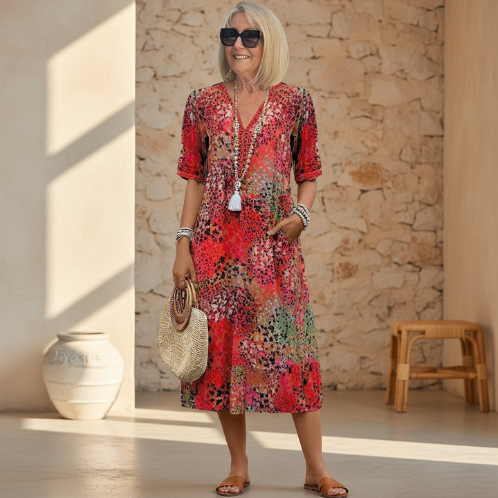 Printed women's V-neck midi dress with eye-catching floral design. A comfortable and stylish choice for summer elegance.