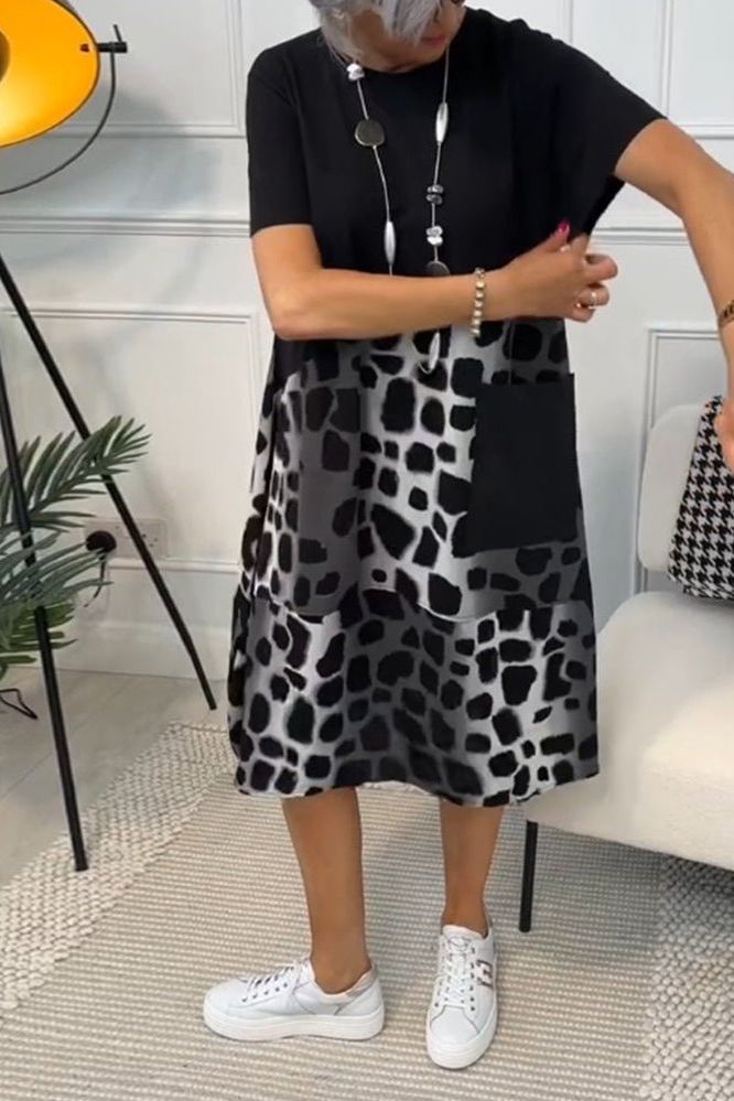 Flowy women's midi dress with vibrant floral print & defined waist. Great for daywear.
