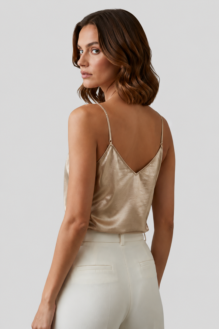 Close-up of a women's gold V-neck camisole, featuring delicate thin straps and an elegant design.