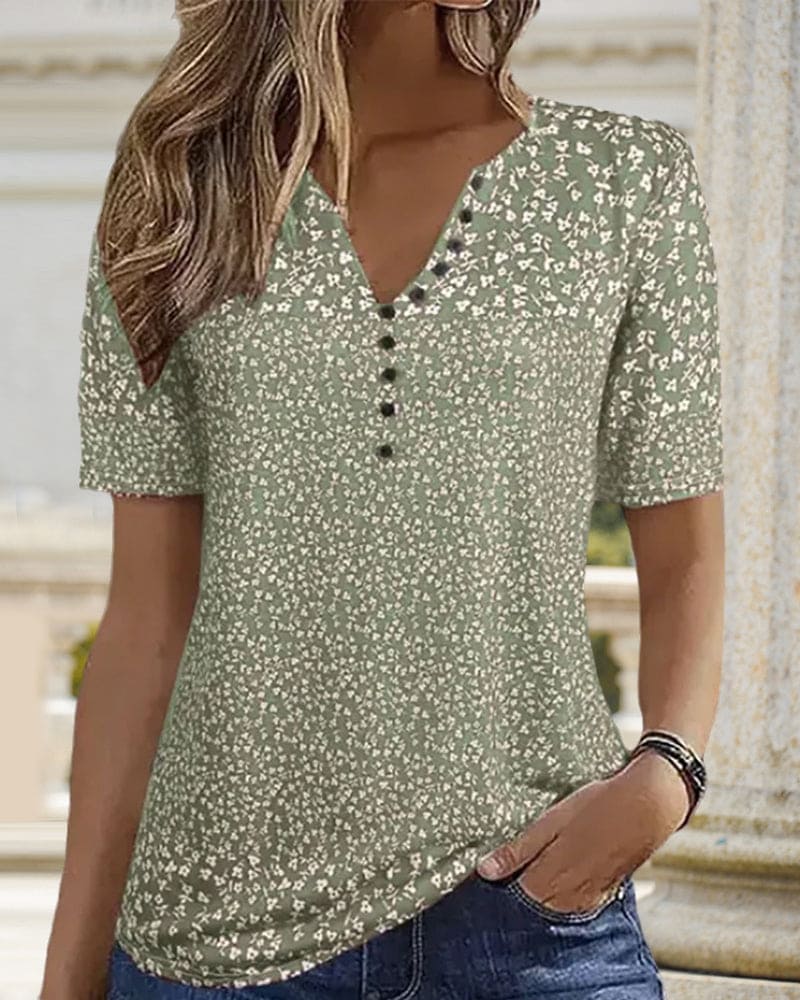 Elegant women's short sleeve floral summer blouse in green. Lightweight and stylish top for casual spring fashion.
