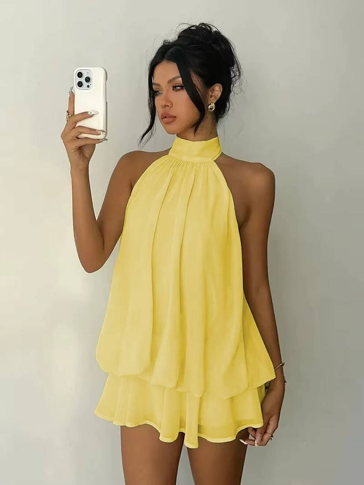 Women's elegant halter mini dress with a flowing ruffle hem and stylish open back, perfect for summer parties.