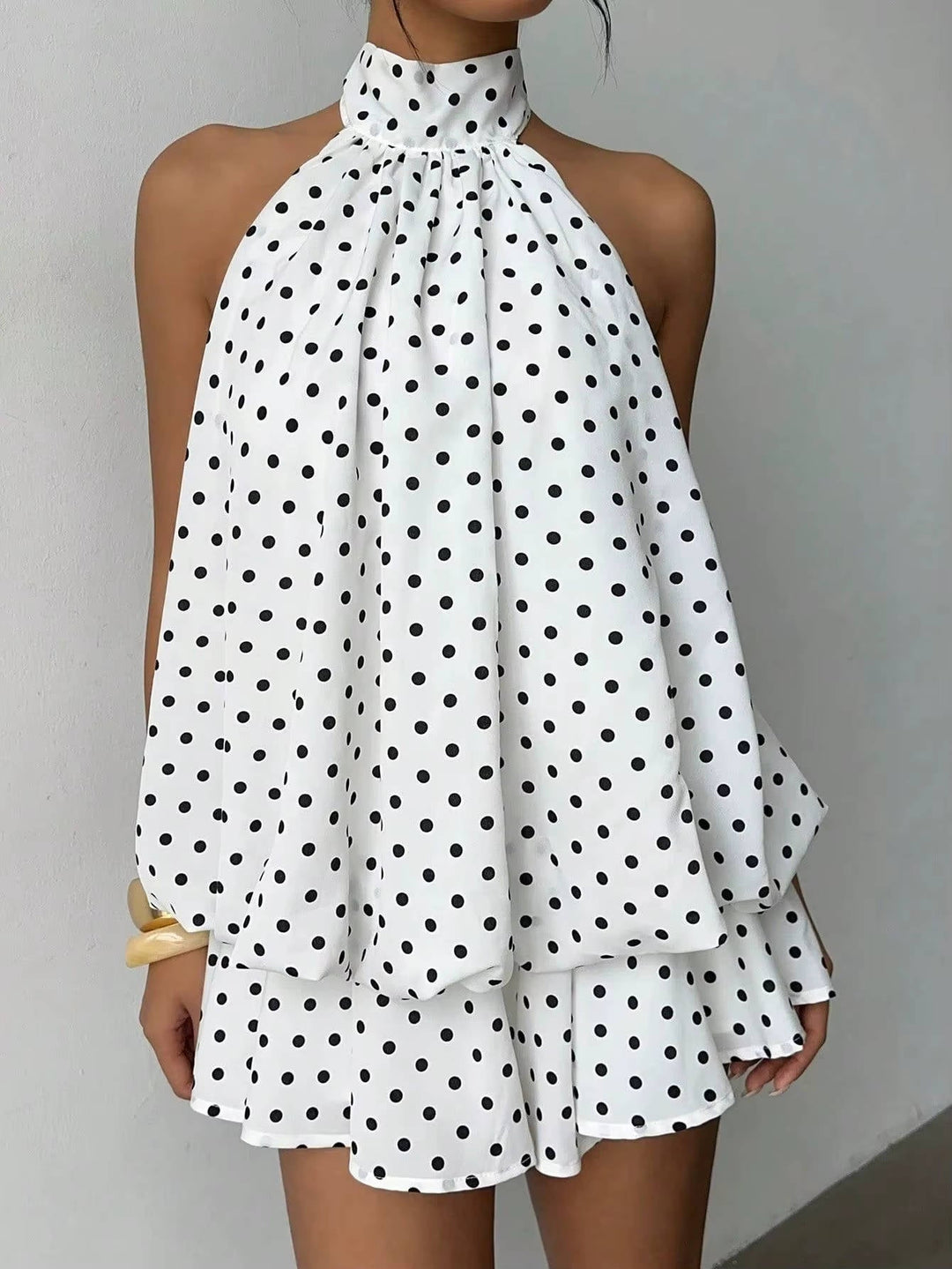 Trendy women's sleeveless halter dress, mini length, featuring a sweet ruffle hem and stylish open back.