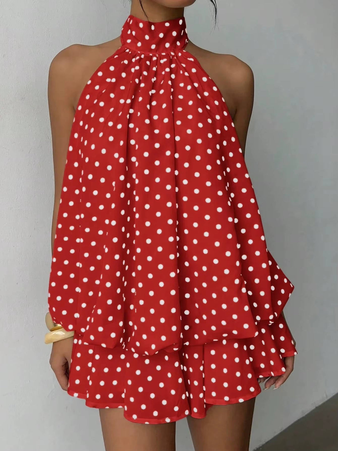 Women's sophisticated open back mini dress, halter neckline, with a beautiful ruffle hem for evenings out.