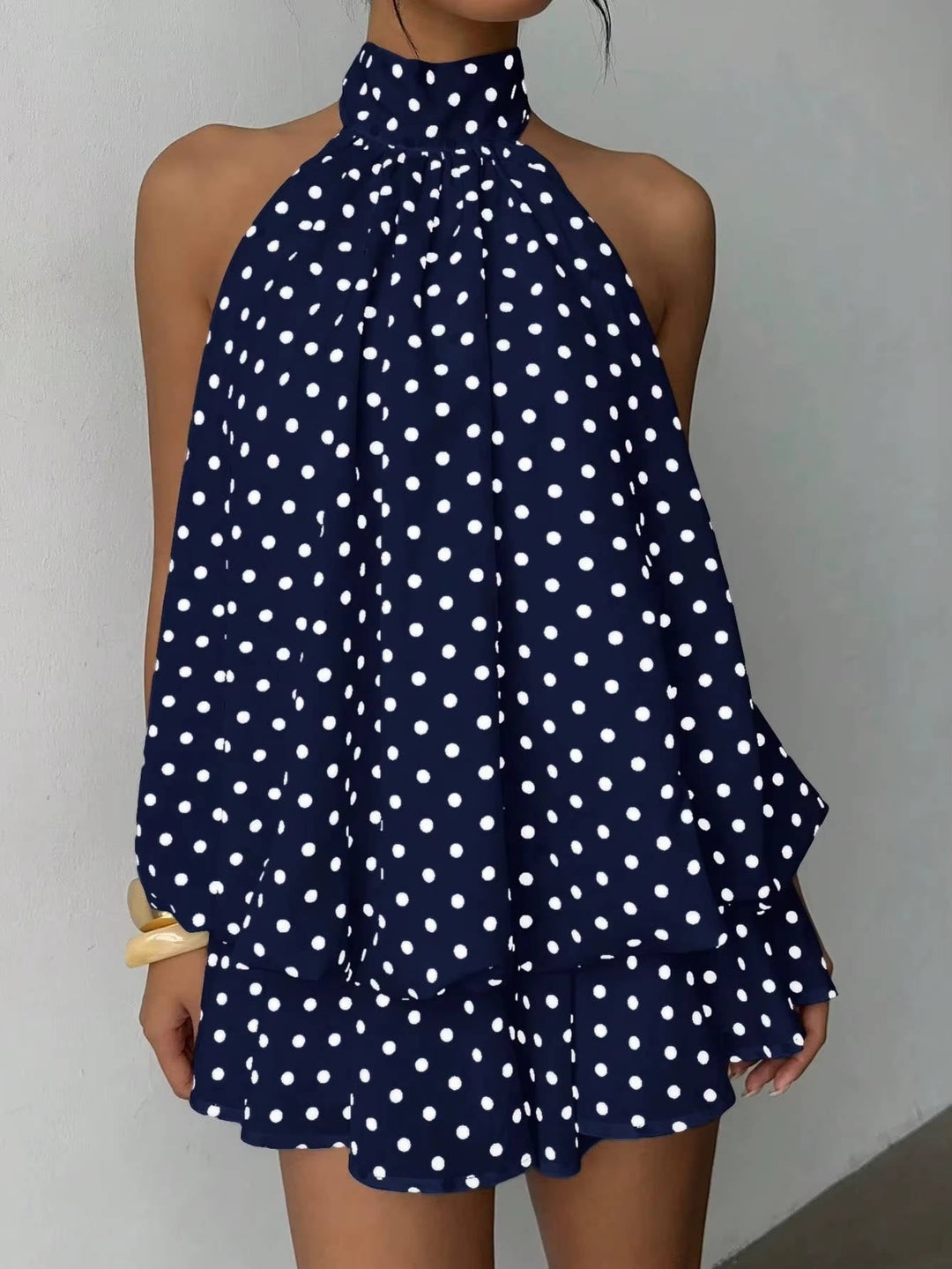 Casual women's summer mini dress, halter style, with a sweet ruffle hem and a comfortable open back.