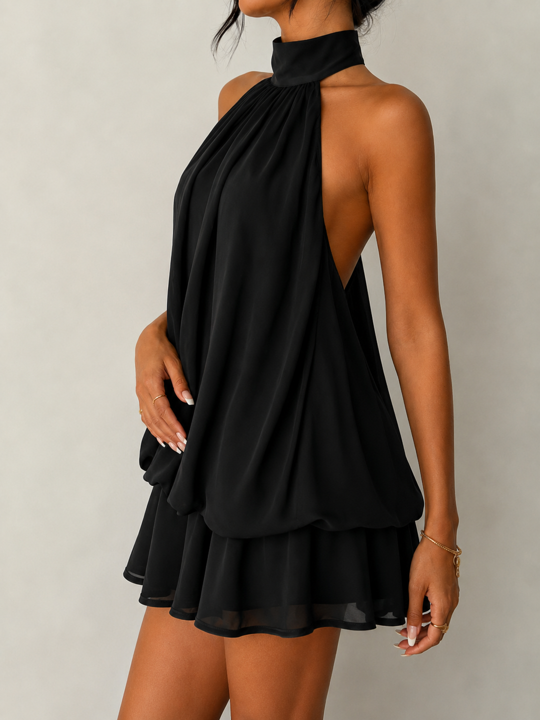 Party-ready women's halter mini dress, featuring a flattering ruffle hem and a stunning open back design.