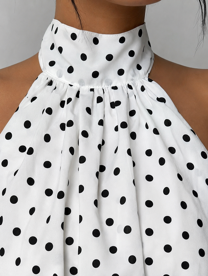 Chic women's sleeveless halter mini dress, featuring a flirty ruffle hem and alluring open back design.