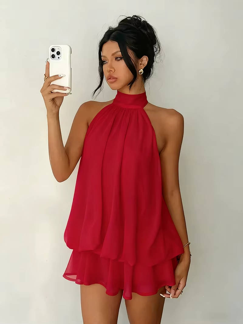 Fashionable women's party halter mini dress, designed with a delicate ruffle hem and a bold open back.
