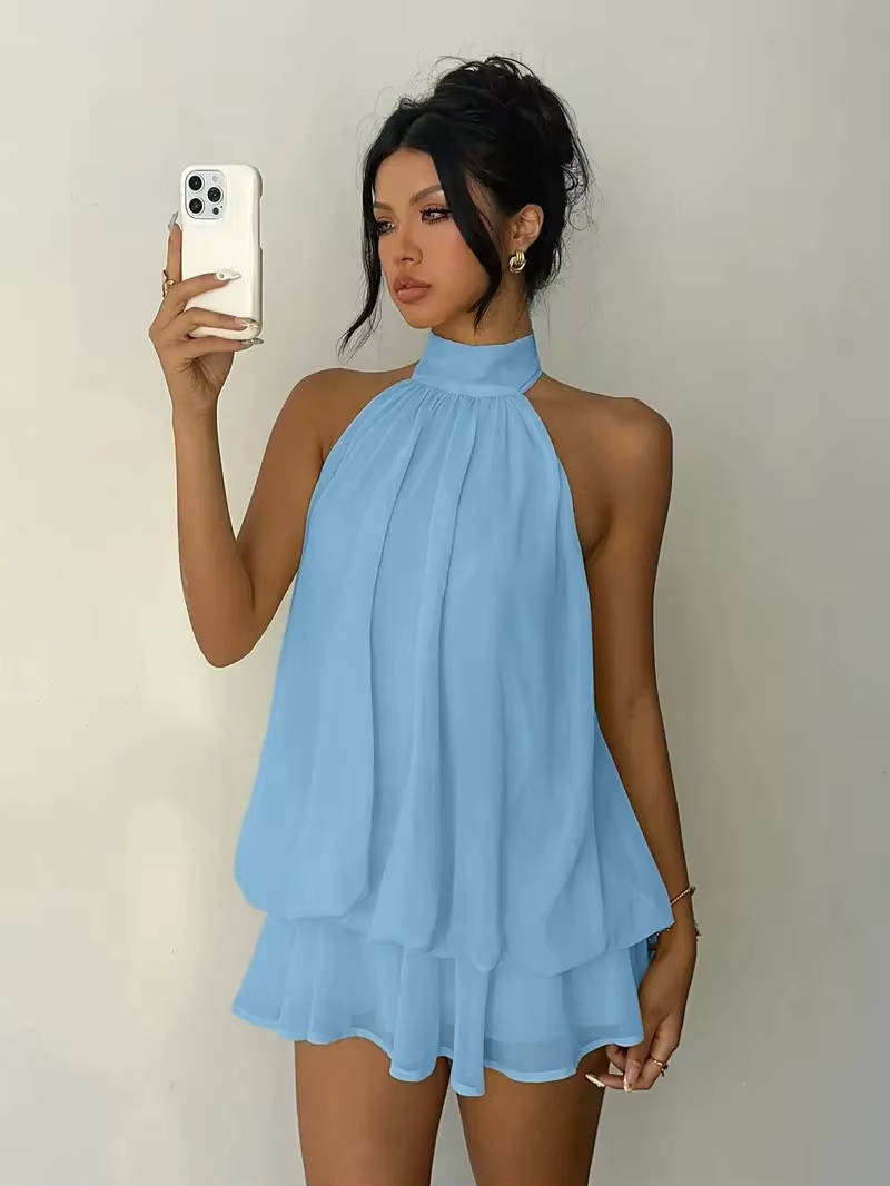 Elegant women's sleeveless mini dress, halter neck, with a playful ruffle hem and alluring open back.