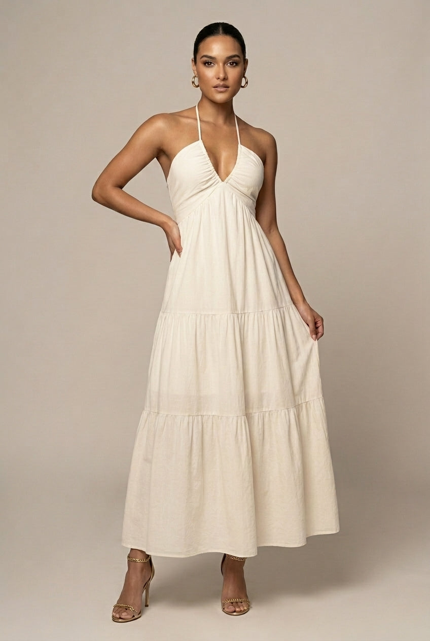 Women's elegant halter neck maxi dress with tiered ruffle skirt, open back, and tie waist for special occasions.