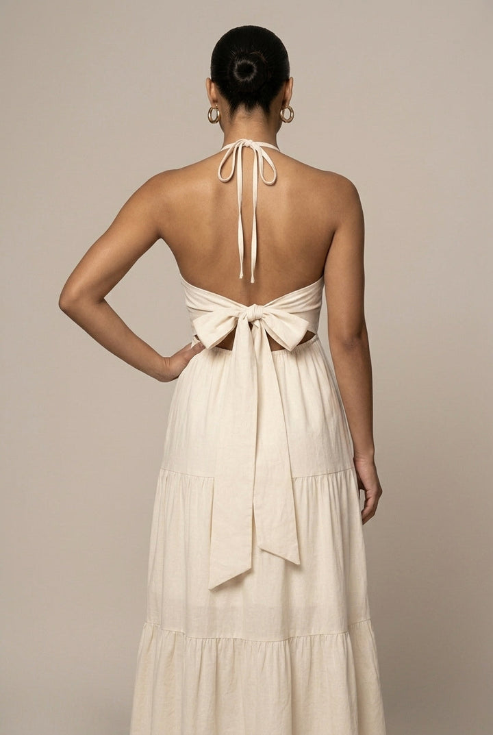 Chic women's open back halter neck maxi dress featuring a tiered ruffle skirt and flattering tie waist.