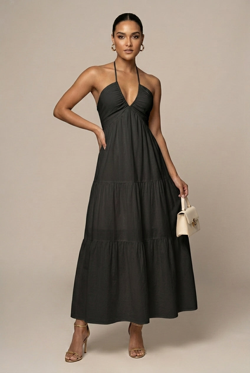 Wedding guest halter neck maxi dress, tiered ruffle skirt, open back, tie waist. Elegant women's occasion wear.