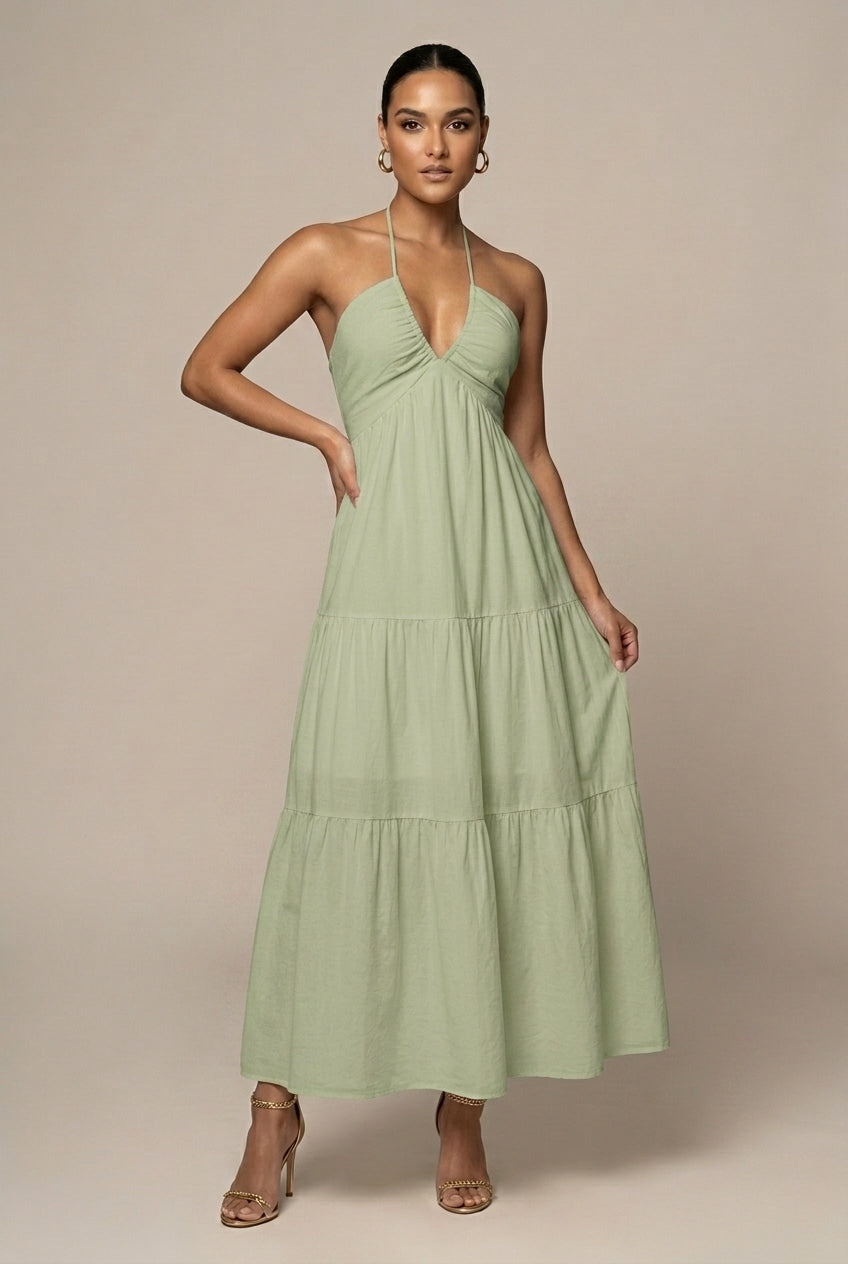 Women's long tiered ruffle skirt maxi dress with halter neckline, open back, and adjustable tie waist.