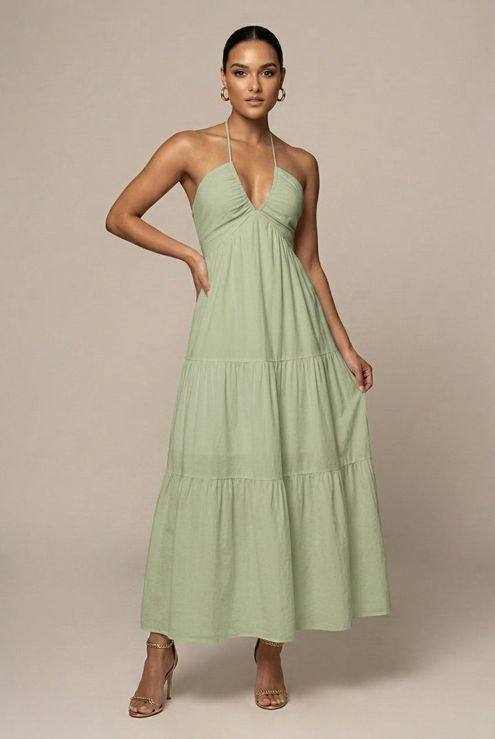 Women's long tiered ruffle skirt maxi dress with halter neckline, open back, and adjustable tie waist.