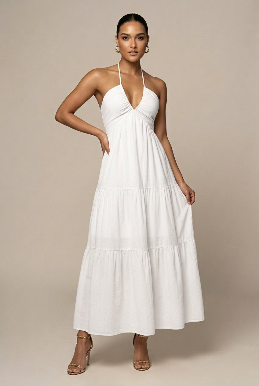 Stylish women's halter neck tiered ruffle maxi dress. Features open back & tie waist, ideal for elegant events.