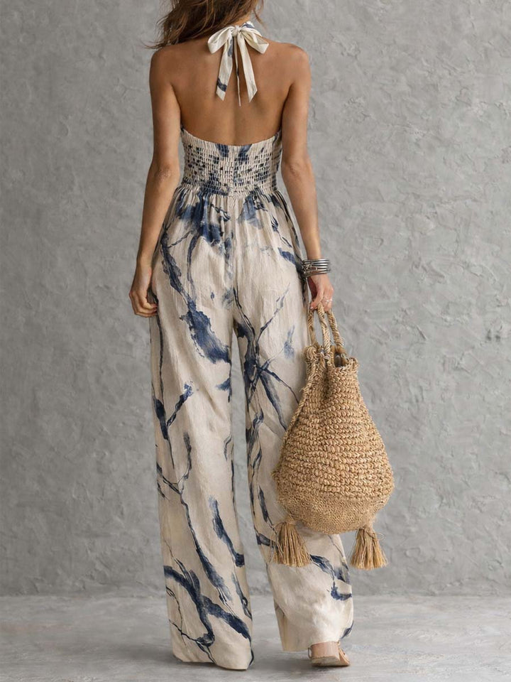 Chic women's halter neck wide leg jumpsuit, featuring deep pockets, ideal for a stylish spring or summer outfit.