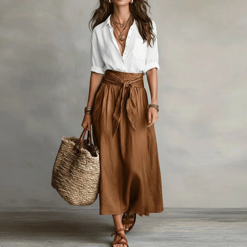 Breathable women's linen matching set; loose-fit blouse and elastic-waist skirt for comfortable summer styling.