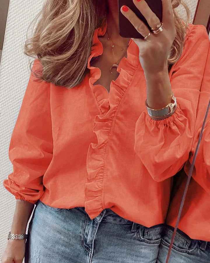 Women's elegant long sleeve ruffle V-neck blouse, versatile for office wear or casual occasions.
