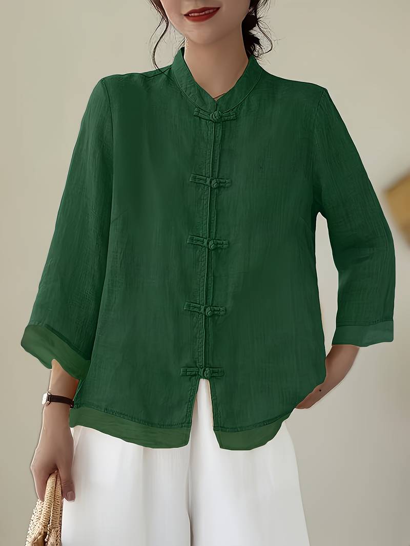 Women's elegant mandarin collar blouse with unique frog buttons, perfect for work or casual events.